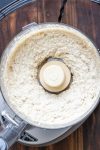 Top view of a food processor with cashew ricotta blending.