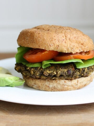 A veggie bean burger on a bun with salad