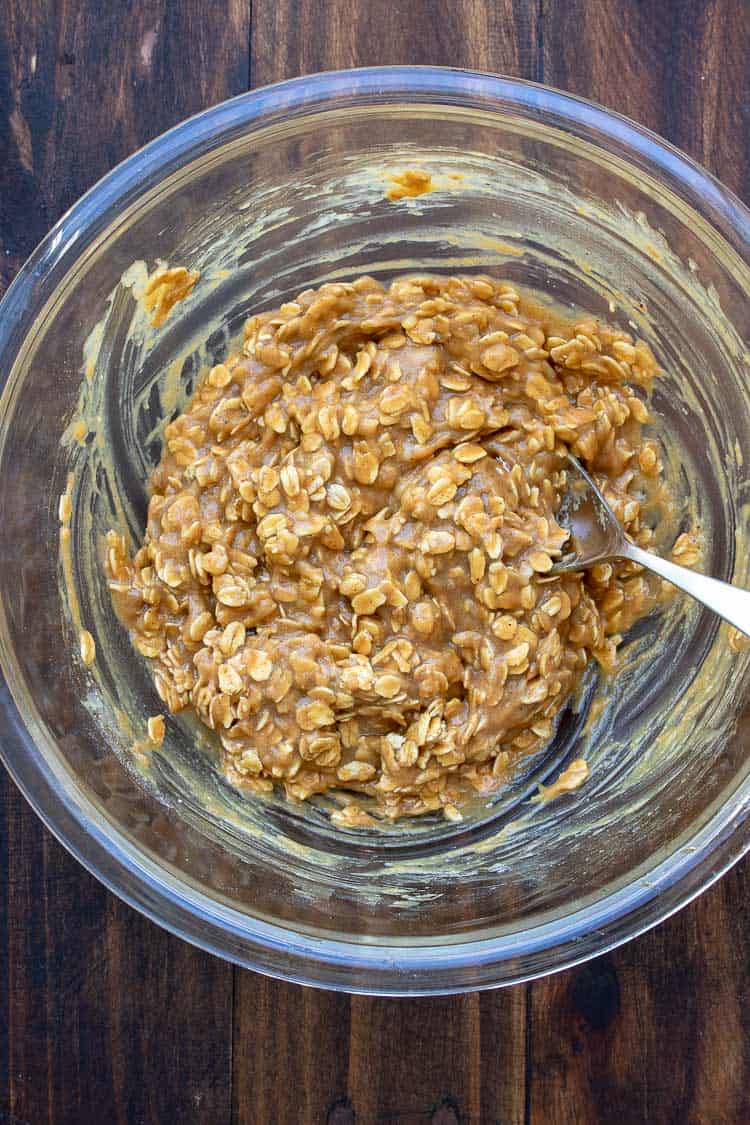 Spoon mixing oat peanut butter cookie batter