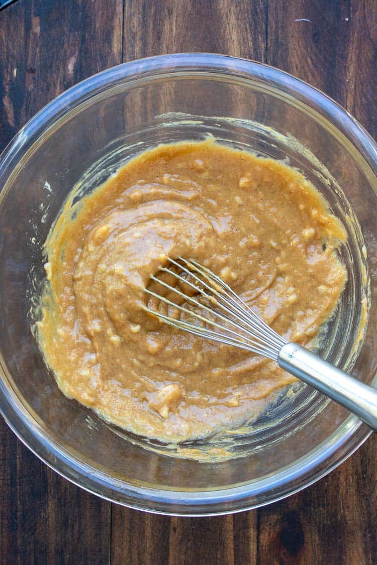 Glass bowl with peanut butter mixture being whisked