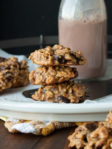 Stack of three oatmeal chocolate chip cookies on a plate