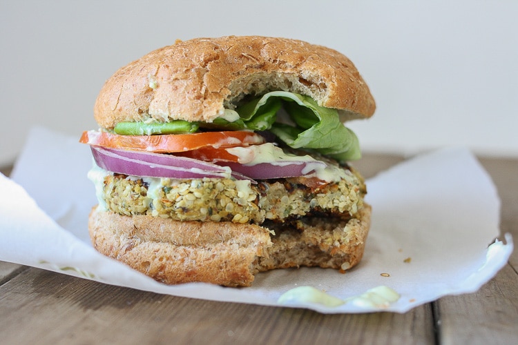 A close up of a Cauliflower burger with a bite out