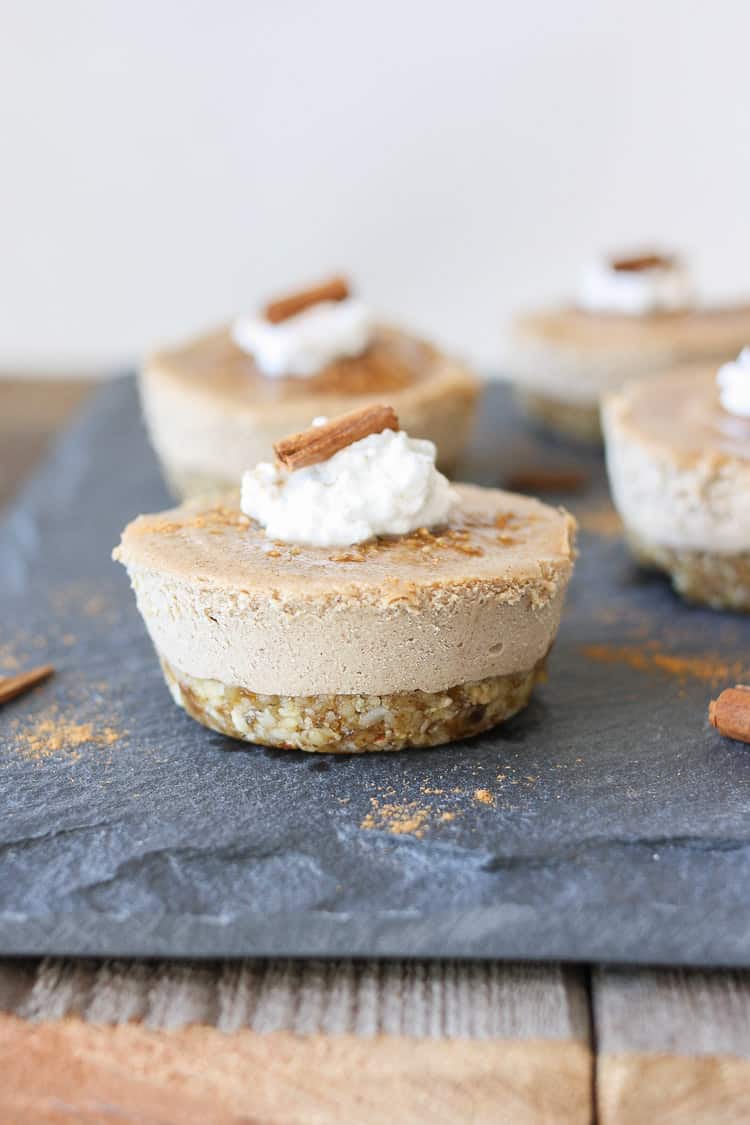 Raw vegan churro cheesecake cups sitting on a slate surface