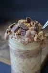 Raw peanut butter chocolate parfait in a jar with a spoon