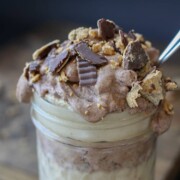 Raw peanut butter chocolate parfait in a jar with a spoon