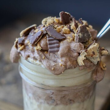 Raw peanut butter chocolate parfait in a jar with a spoon