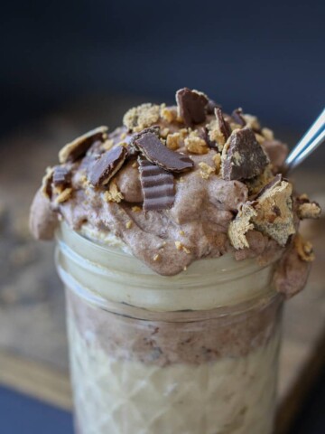 Raw peanut butter chocolate parfait in a jar with a spoon