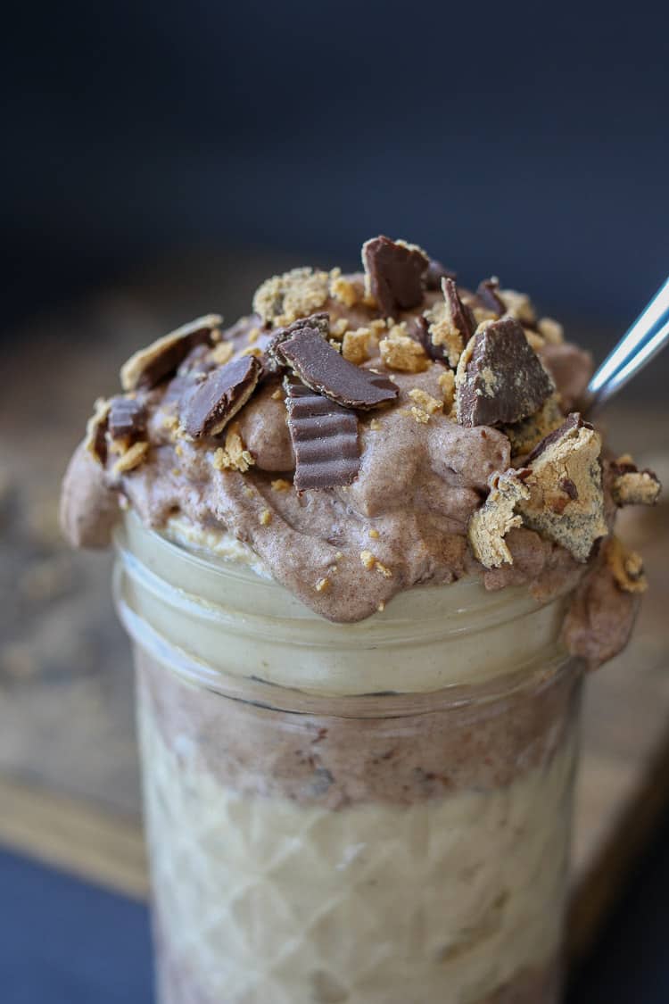 Raw peanut butter chocolate parfait in a jar with a spoon