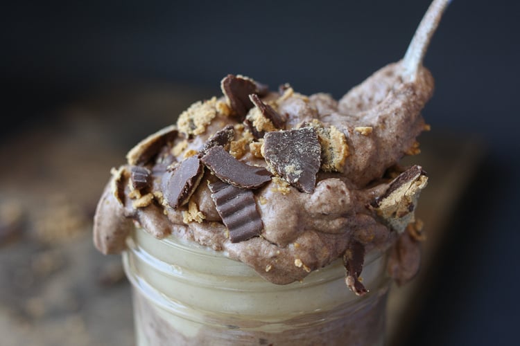 A close up of a Raw peanut butter chocolate parfait in a glass jar