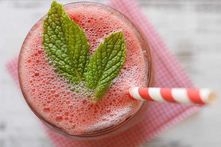An overhead shot of a watermelon cooler topped with mint leaves