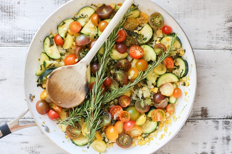 An overhead shot of summer vegetables in a pan