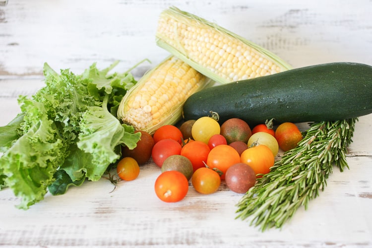 Summer vegetables on a wooden surface used for making vegetable linguine