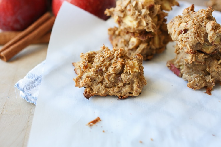 Apple Cinnamon Date Muffin Scones on baking parchment with cinnamon sticks in the background