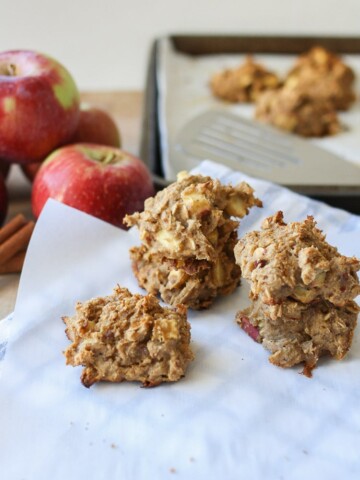 Three Apple Cinnamon Date Muffin Scones sitting on baking parchment