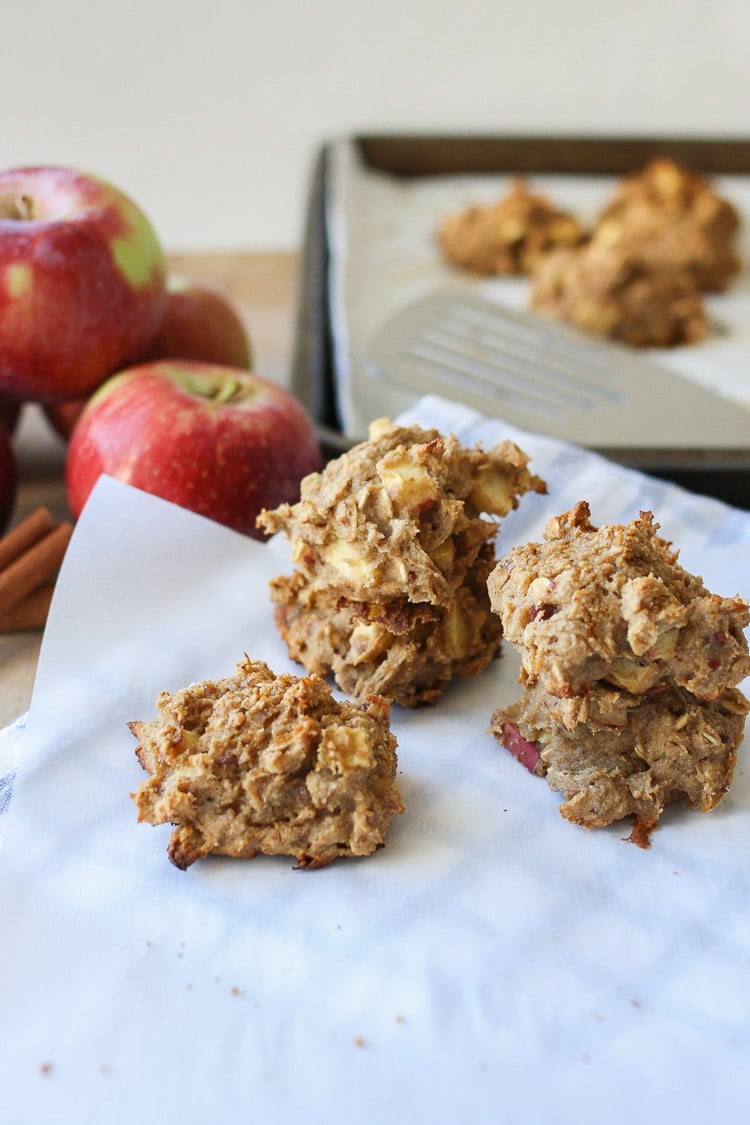 Three Apple Cinnamon Date Muffin Scones sitting on baking parchment