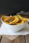 Baked Kabocha squash chips with thyme in a white bowl