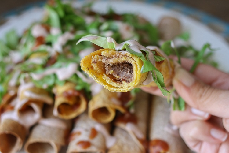 A close up of Rolled Tacos with a bite out