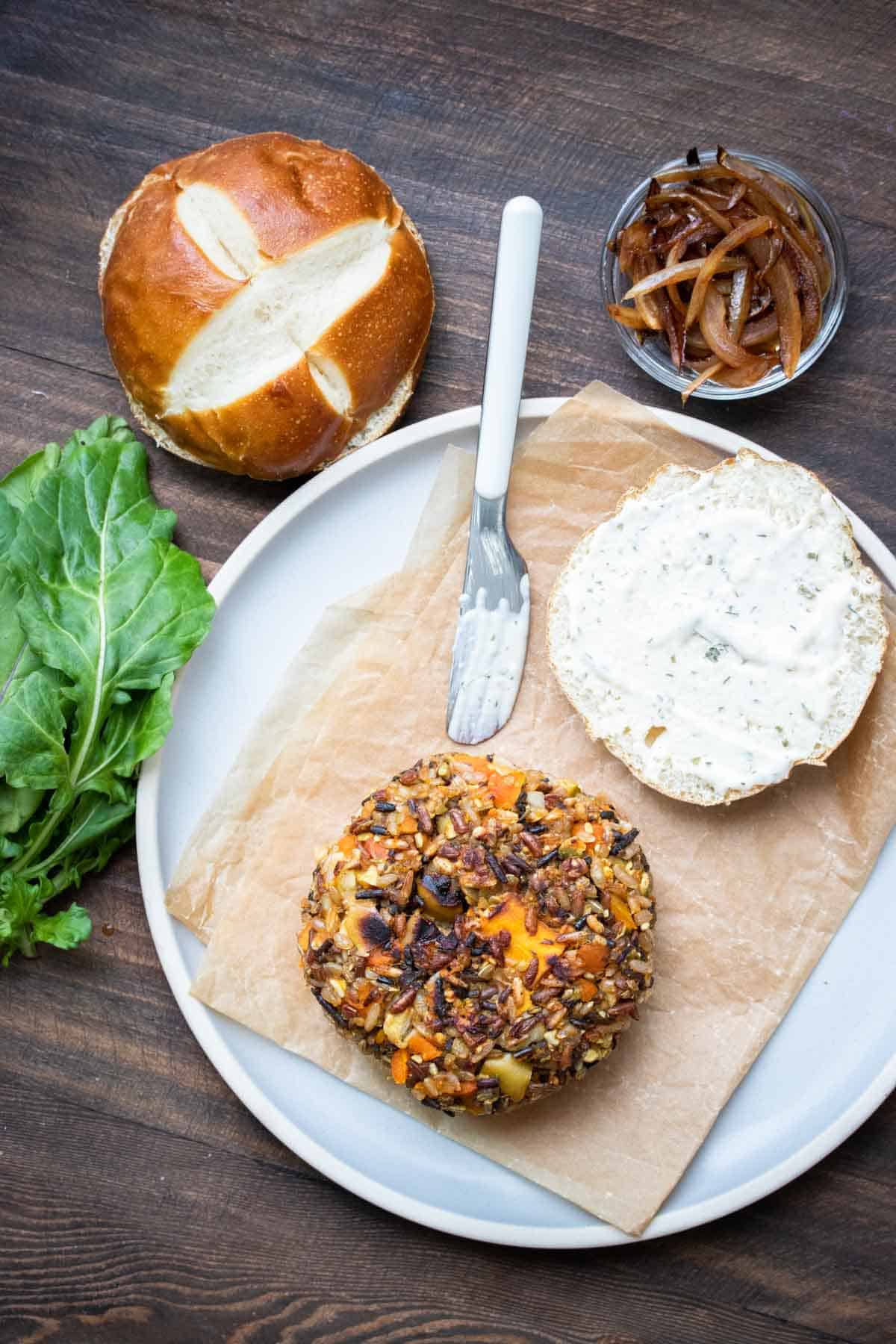 Top view of open faced butternut squash burger on a while plate.