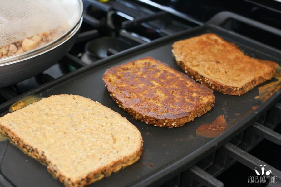 Cinnamon apple french toast getting fried on a stove