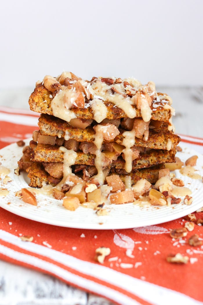 Cinnamon apple french toast with salted caramel icing stacked up on a plate