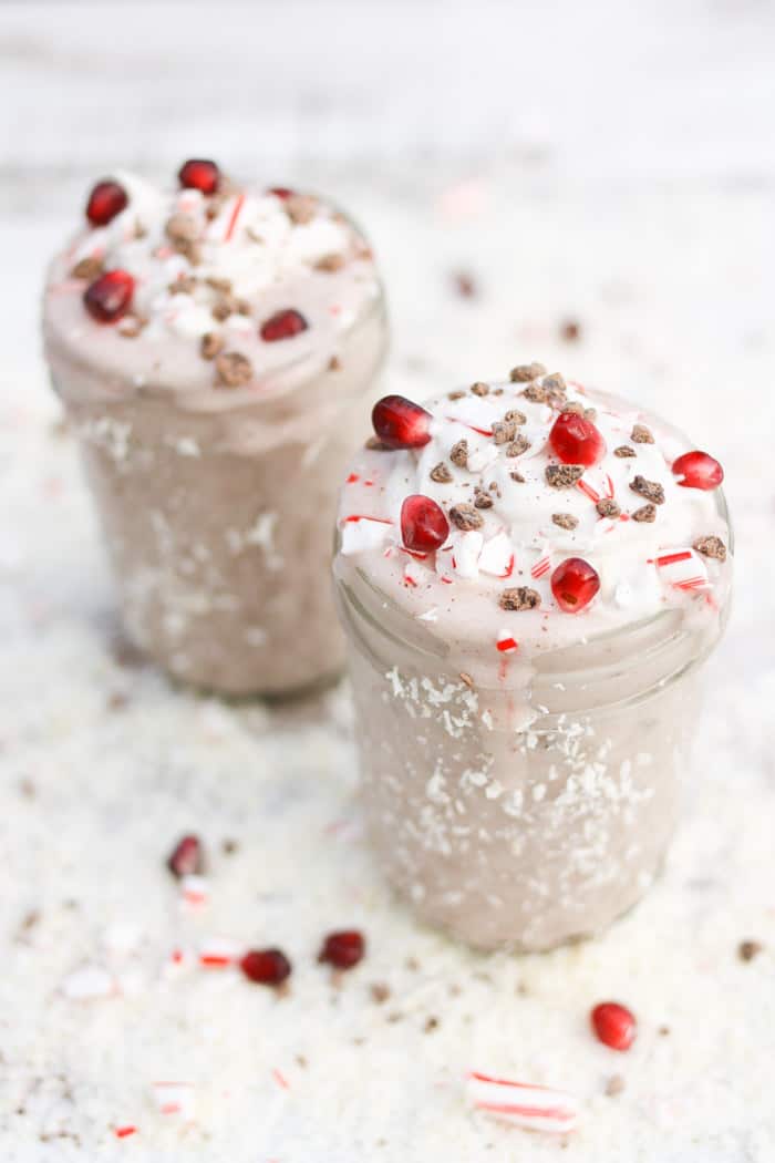 A Chocolate covered candy cane milk shake in a mason jar 