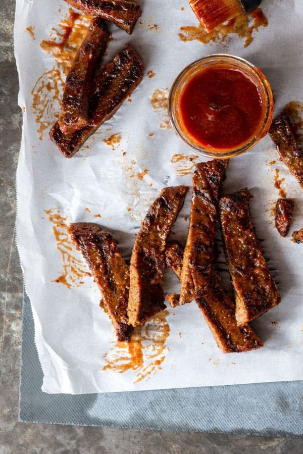 Vegan ribs with barbecue sauce on a piece of parchment