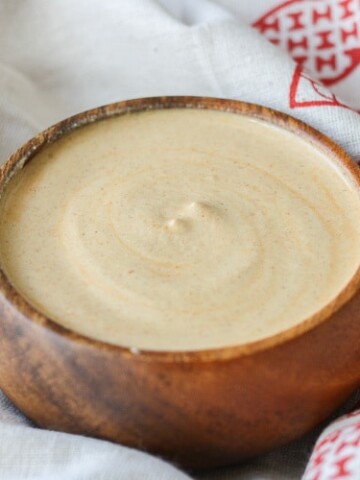 A small wooden bowl filled with Pistachio buffalo cream