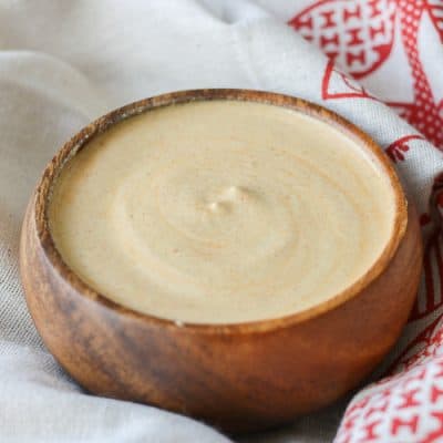 A small wooden bowl filled with Pistachio buffalo cream