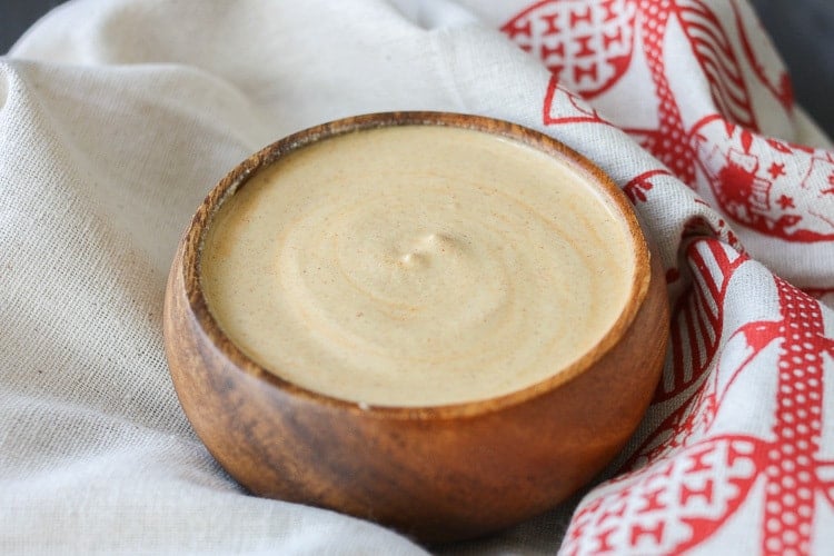 A small wooden bowl filled with Pistachio buffalo cream