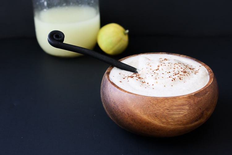 A small wooden bowl of Tangy Chili Lime sauce with a black spoon