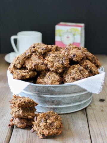 Vegan chocolate chip oat cookies in a bowl piled high