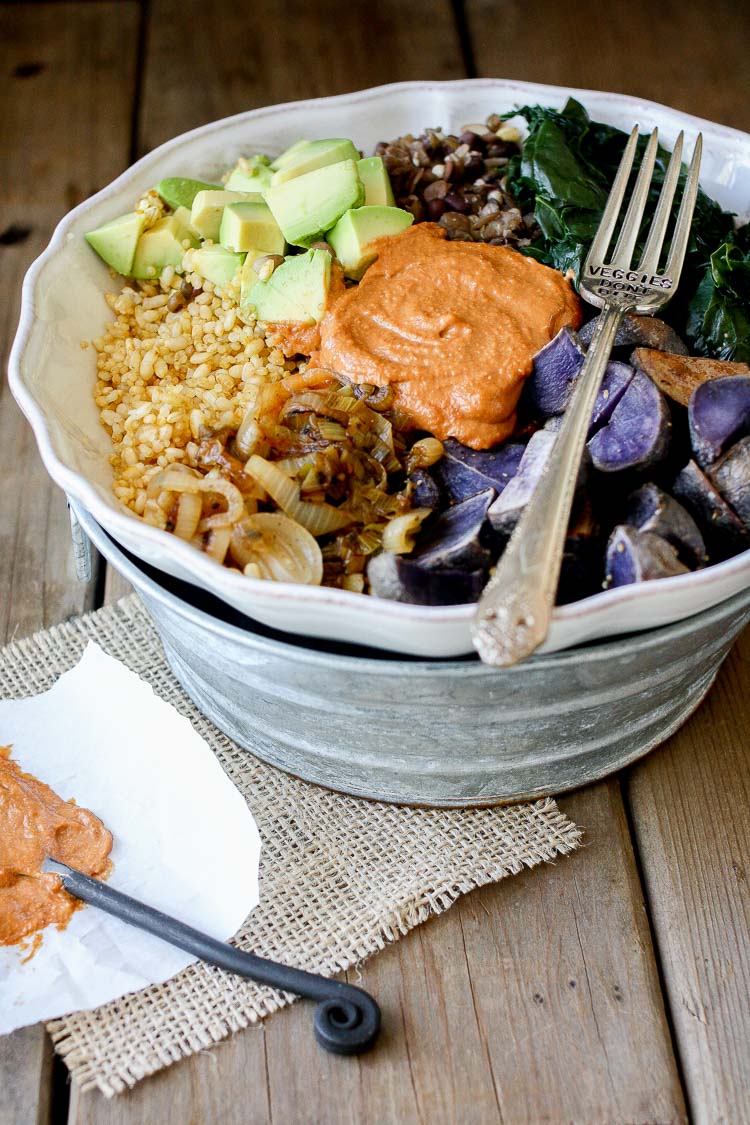 A side shot of a Barbecue Tahini power bowl with spinach, swiss chard and potatoes