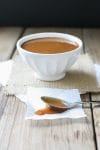 A side shot of Maple Miso Balsamic Sauce in a white bowl