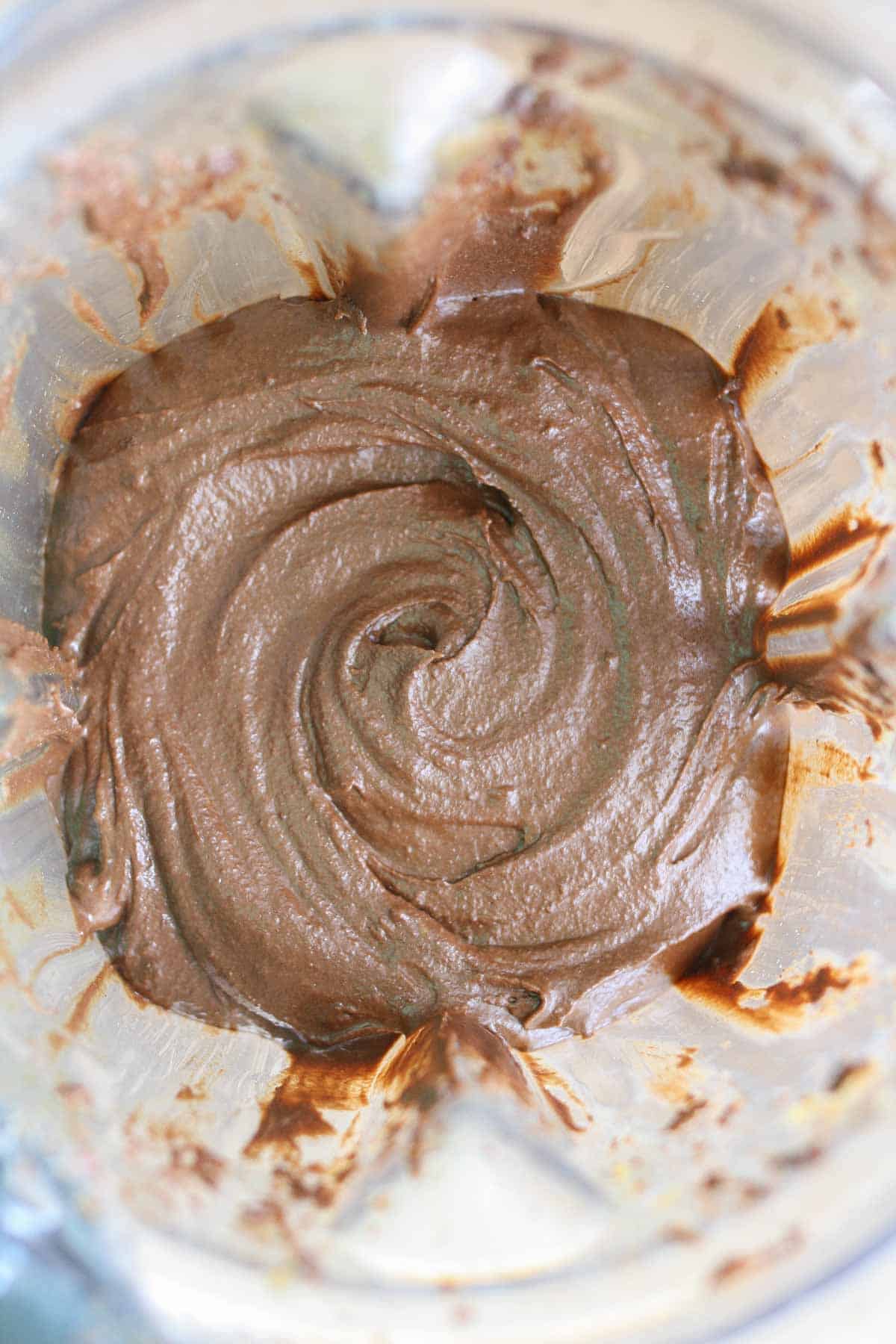 An overhead shot of a Sriracha tahini fudge mixture in a blender