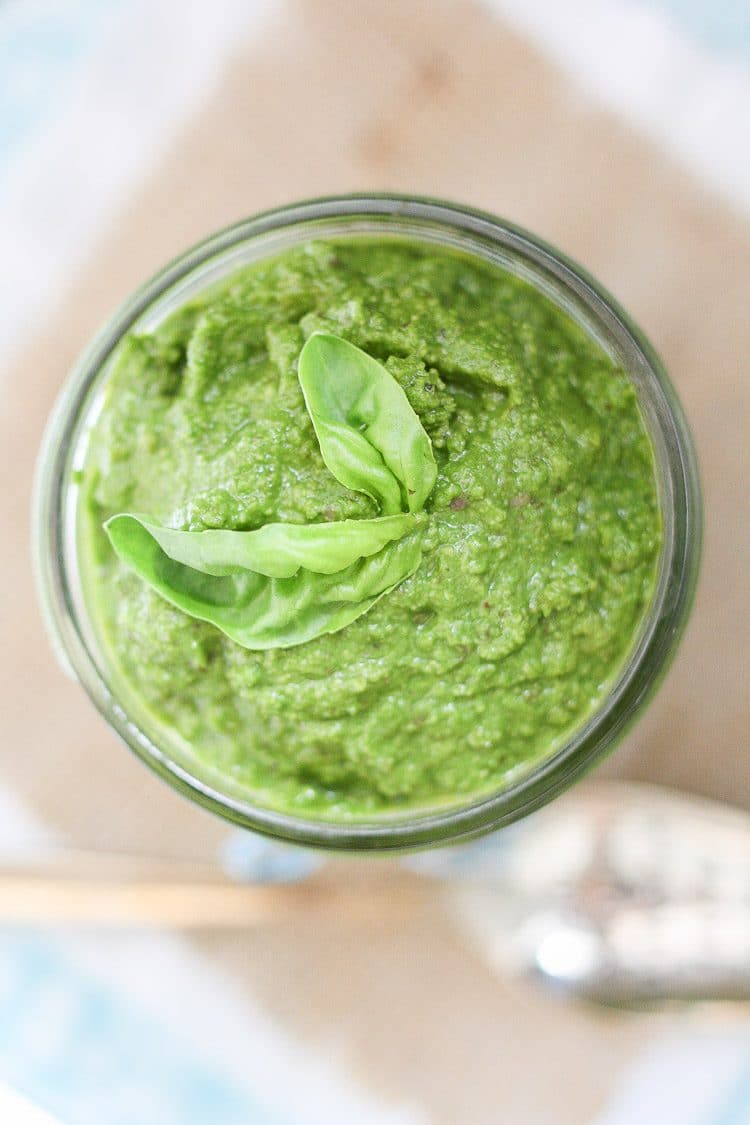 A close up overhead shot of a Vegan Spinach Pesto in a glass jar