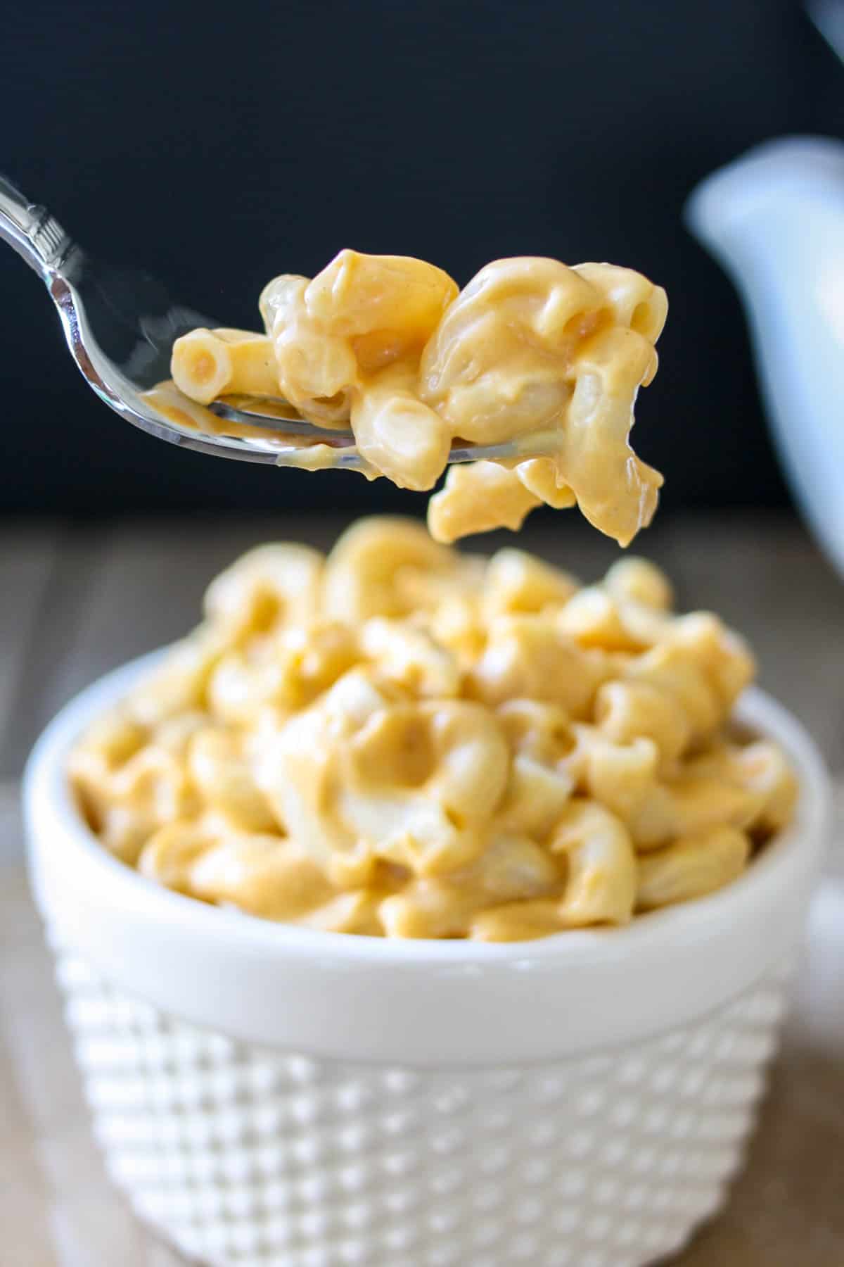 Fork with a bite of creamy vegan mac and cheese on it