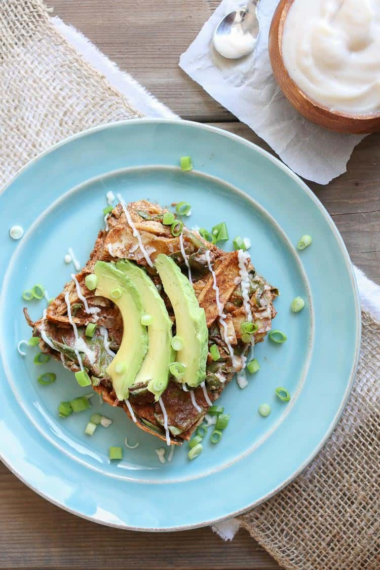 A slice of Enchilada Noodles casserole on a plate with avocado