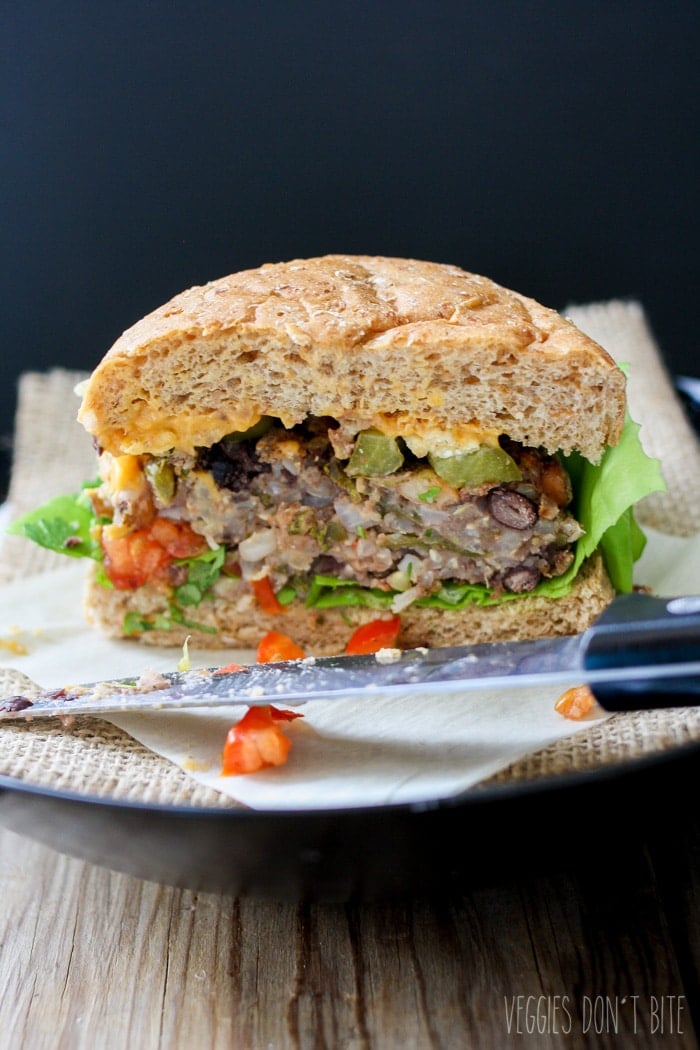 A photo of the Ultimate Mexican nacho burger cut in half on a plate