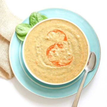 Vegan bean soup in a white bowl with an orange swirl on top