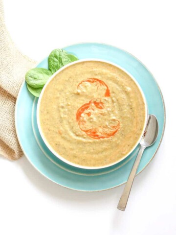 Vegan bean soup in a white bowl with an orange swirl on top