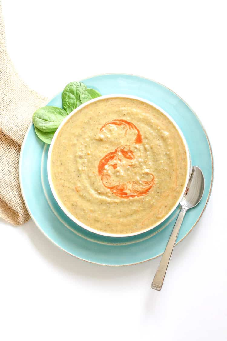 Vegan bean soup in a white bowl with an orange swirl on top