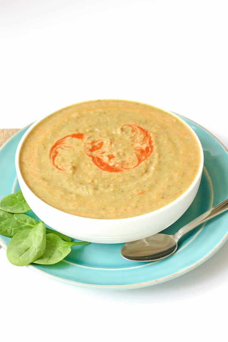 Vegan bean soup in a white bowl sitting on a blue plate