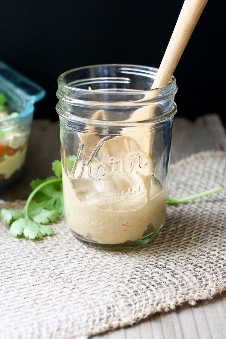 Creamy taco sauce in a jar with a wooden spoon