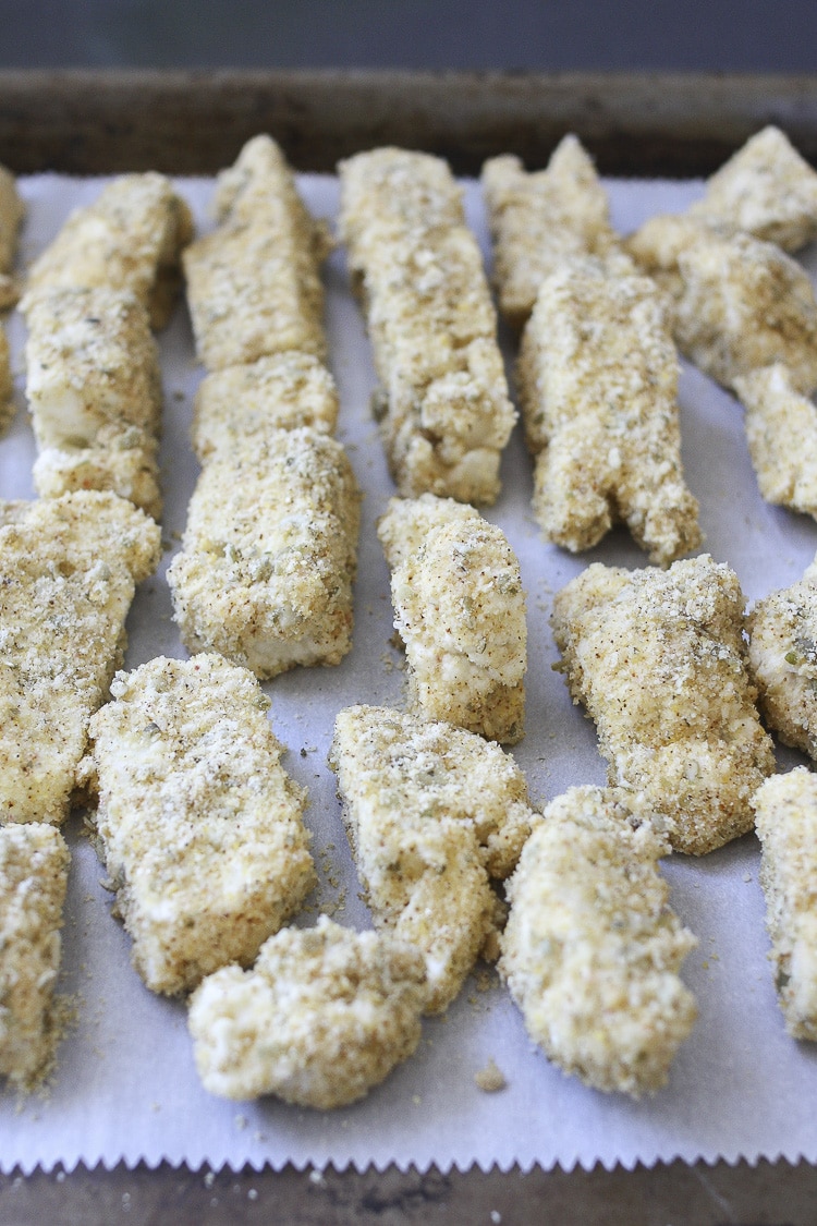 Tray filled with baked crispy cauliflower pieces on parchment paper