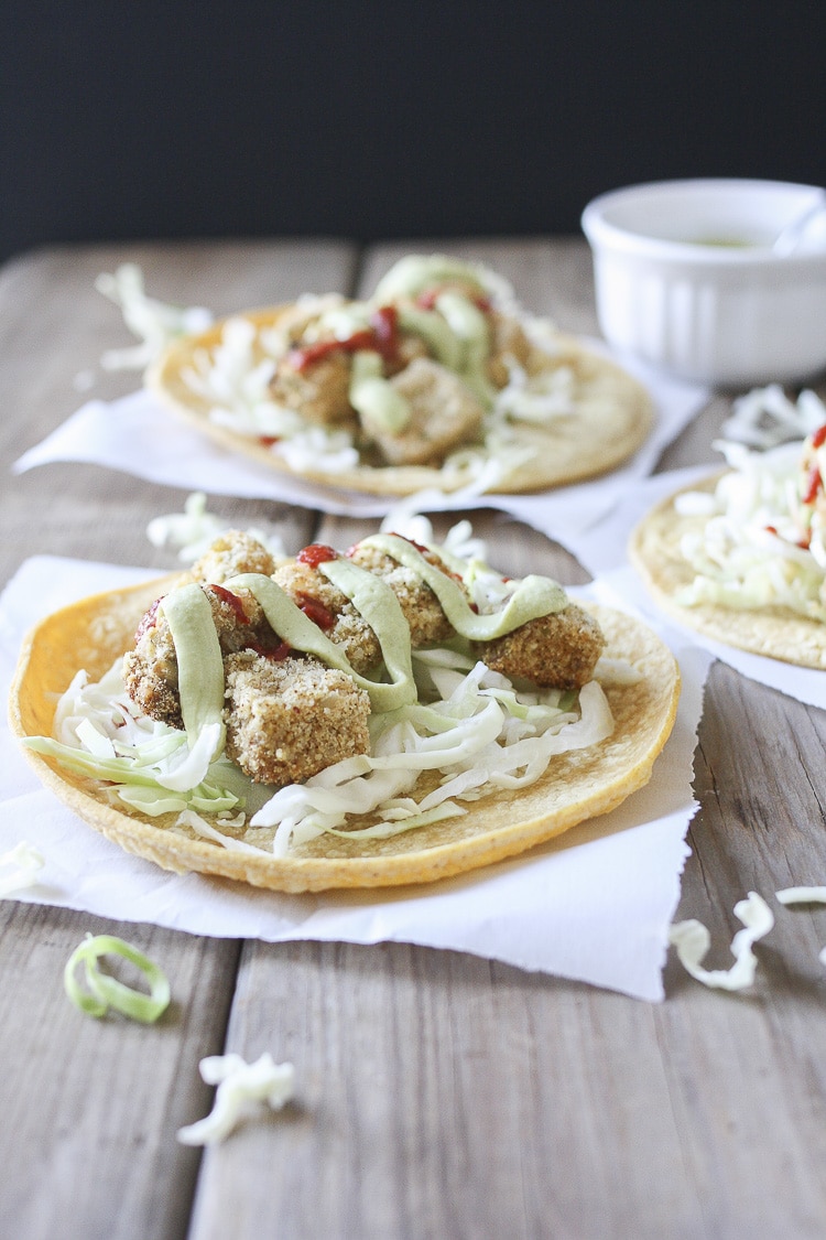 Corn tortilla topped with cabbage, crispy cauliflower and potatoes and dill sauce