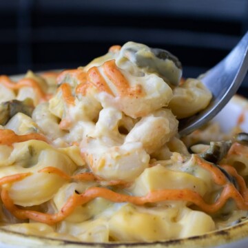 Close up of fork getting a scoop of mac and cheese with poblano peppers