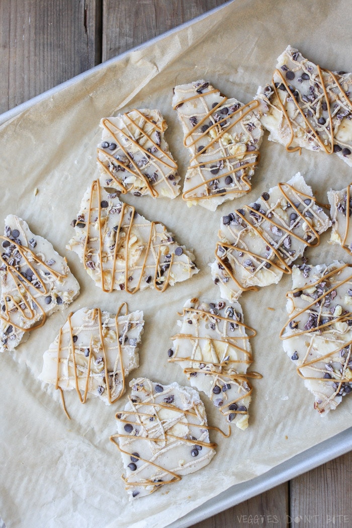 An overhead shot of Vegan Chunky Monkey Frozen Yogurt Bark broken into pieces on a baking tray