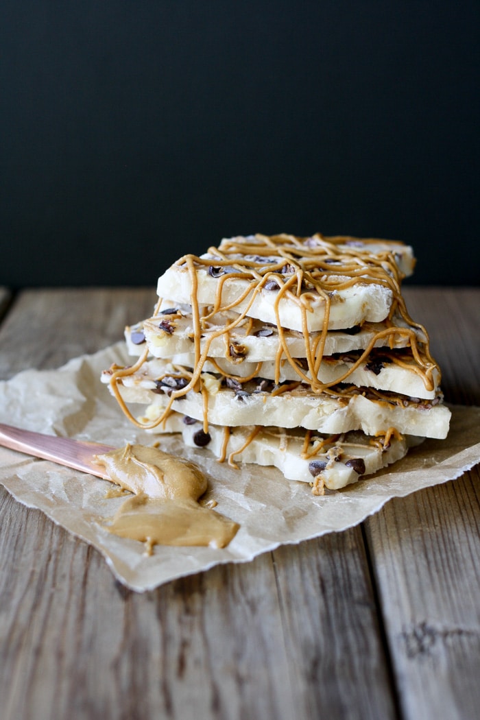 A close up stack of Chunky Monkey Frozen Yogurt Bark on a wooden surface