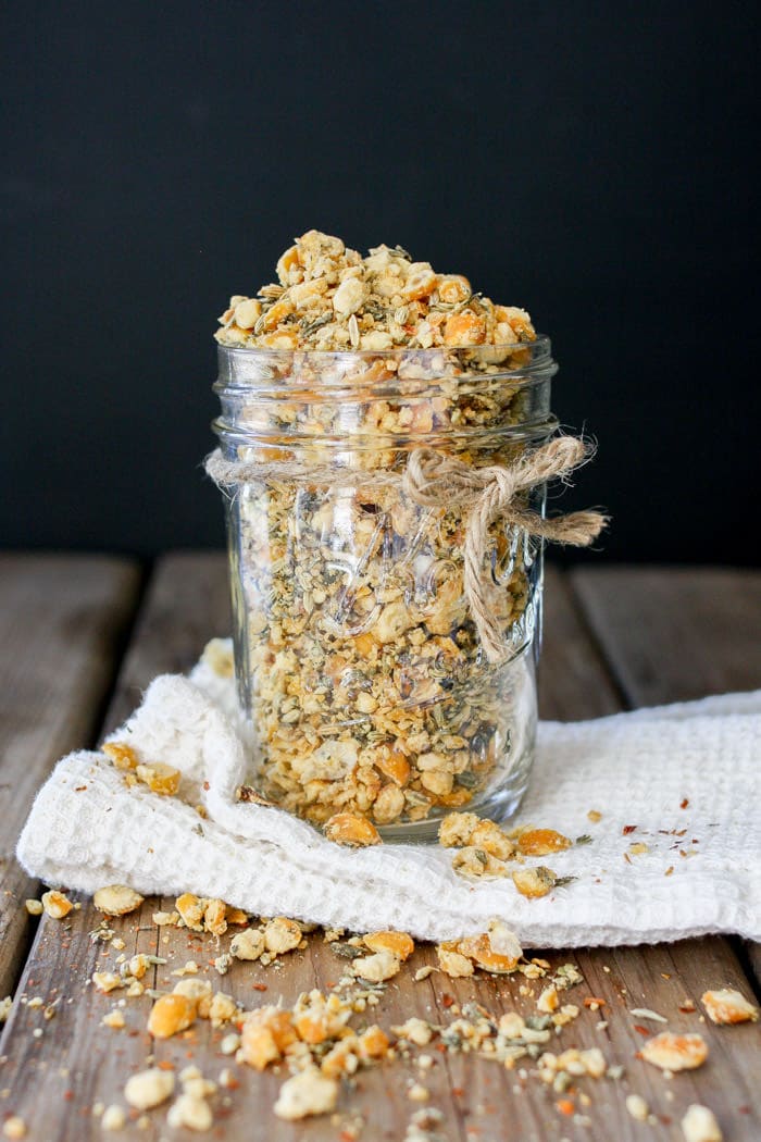 A photo of vegan sausage crumbles in a glass jar on a wooden surface