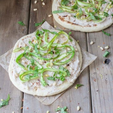 A side shot of an asparagus flatbread with white bean puree